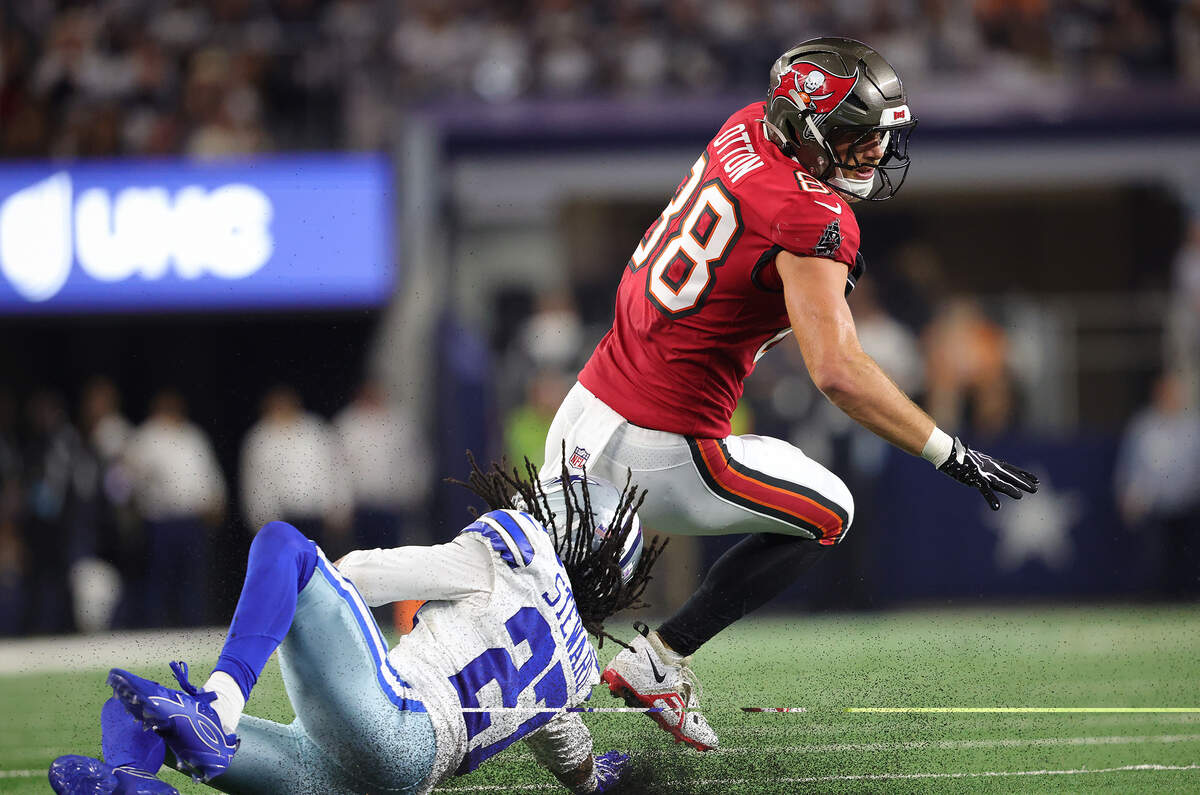 Tampa Bay Buccaneers tight end Cade Otton (88) evades Dallas Cowboys cornerback Reddy Steward on Thursday, Oct. 8, 2026, at AT&T Stadium in Arlington.